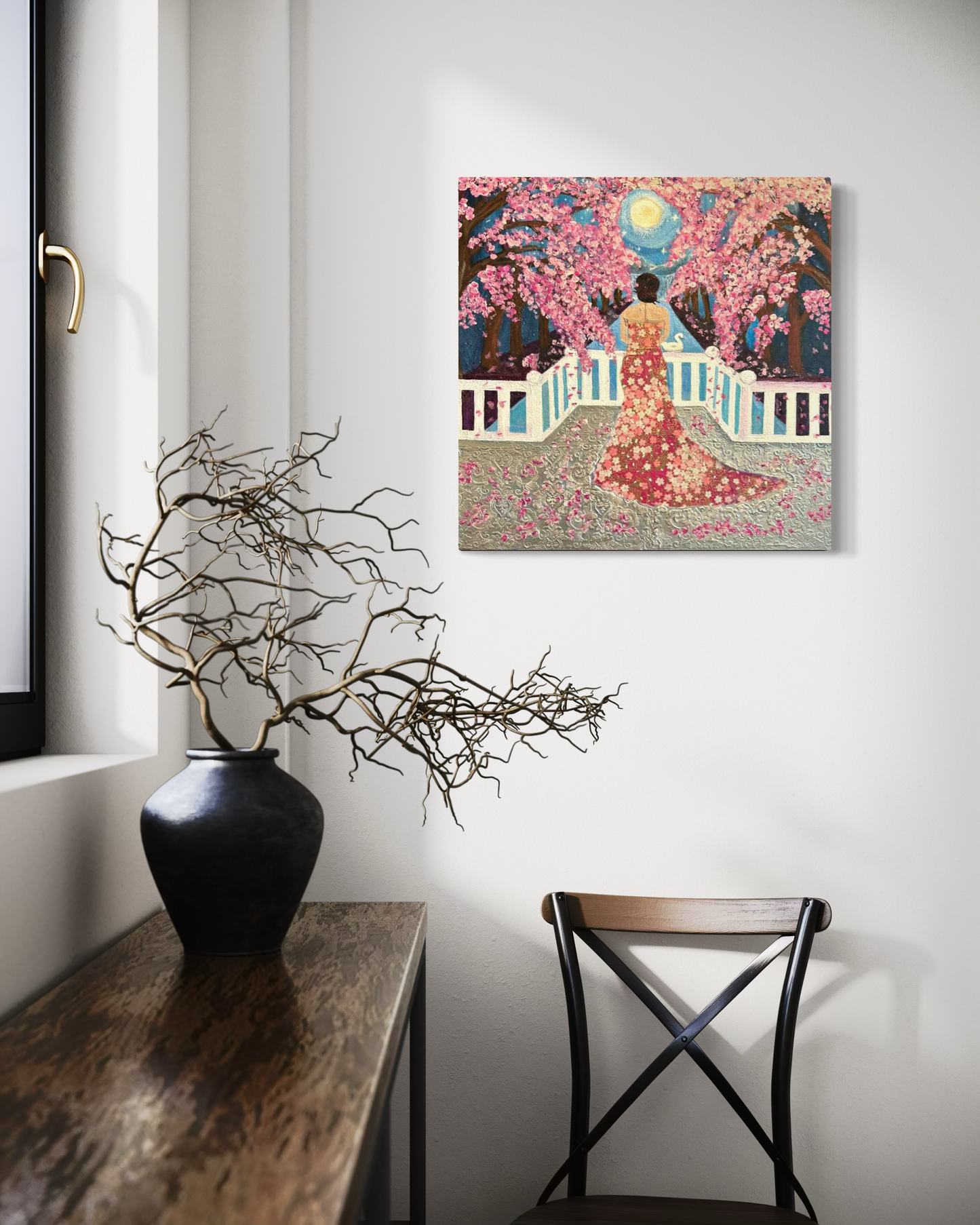Decorative interior with a vase, branches, and a painting of a woman in a garden.