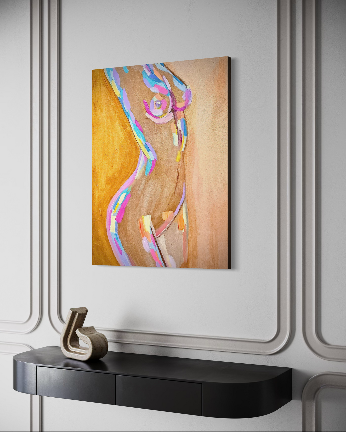 Abstract art piece on a wall above a black console table.