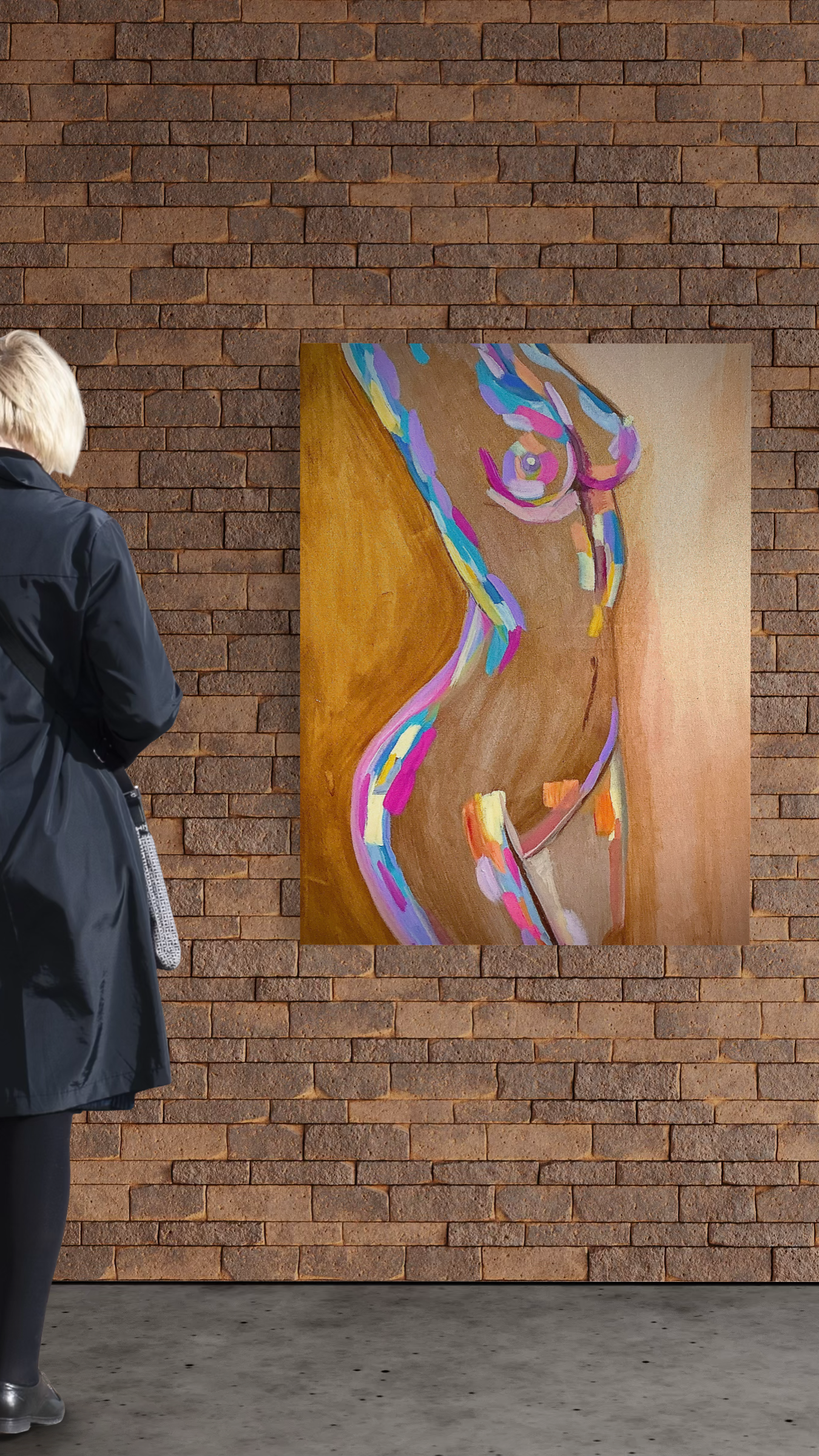 Person viewing a colorful abstract painting on a brick wall