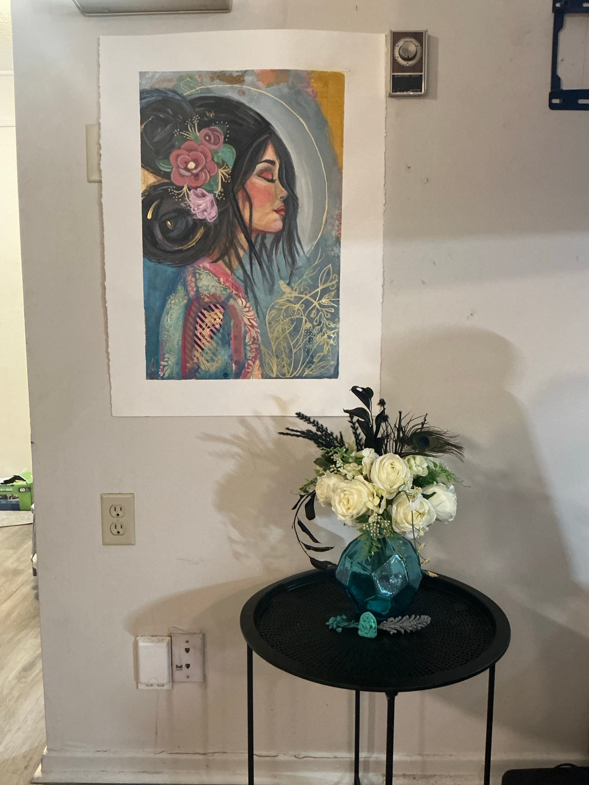 Room view mockup of floral profile fine art print above table with flowers